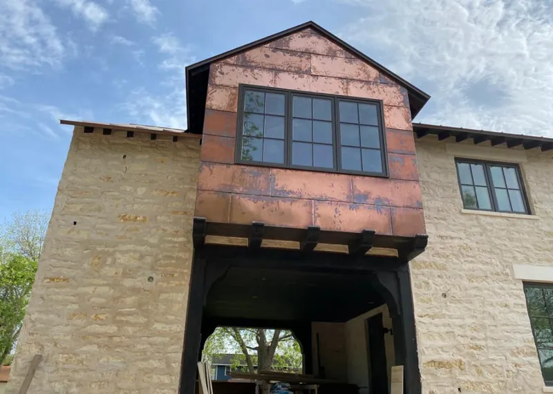 Copper metal panel facade on a stone building for Roof Repair in Cave Creek