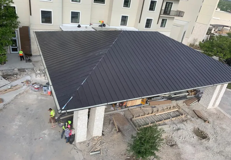 Metal roofing installation team working on a commercial building in Cave Creek